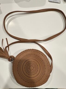Round Perforated Crossbody Bag in Cognac Brown